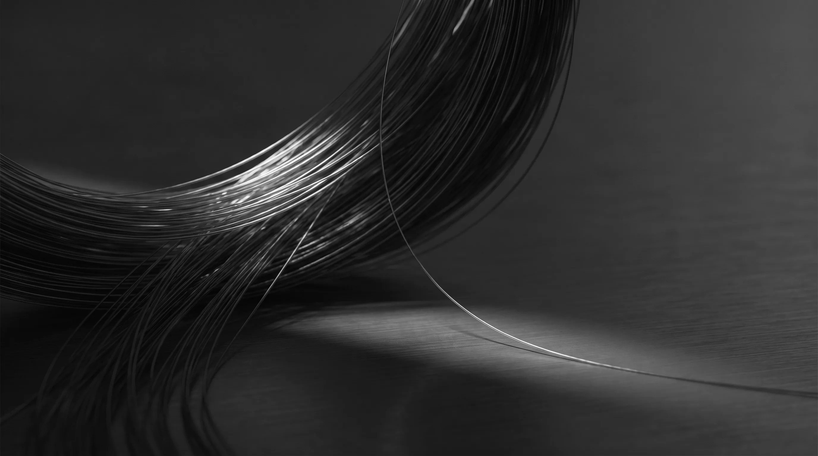 Woven strands of fiber-optic light across brushed steel, representing the group's AI infrastructure