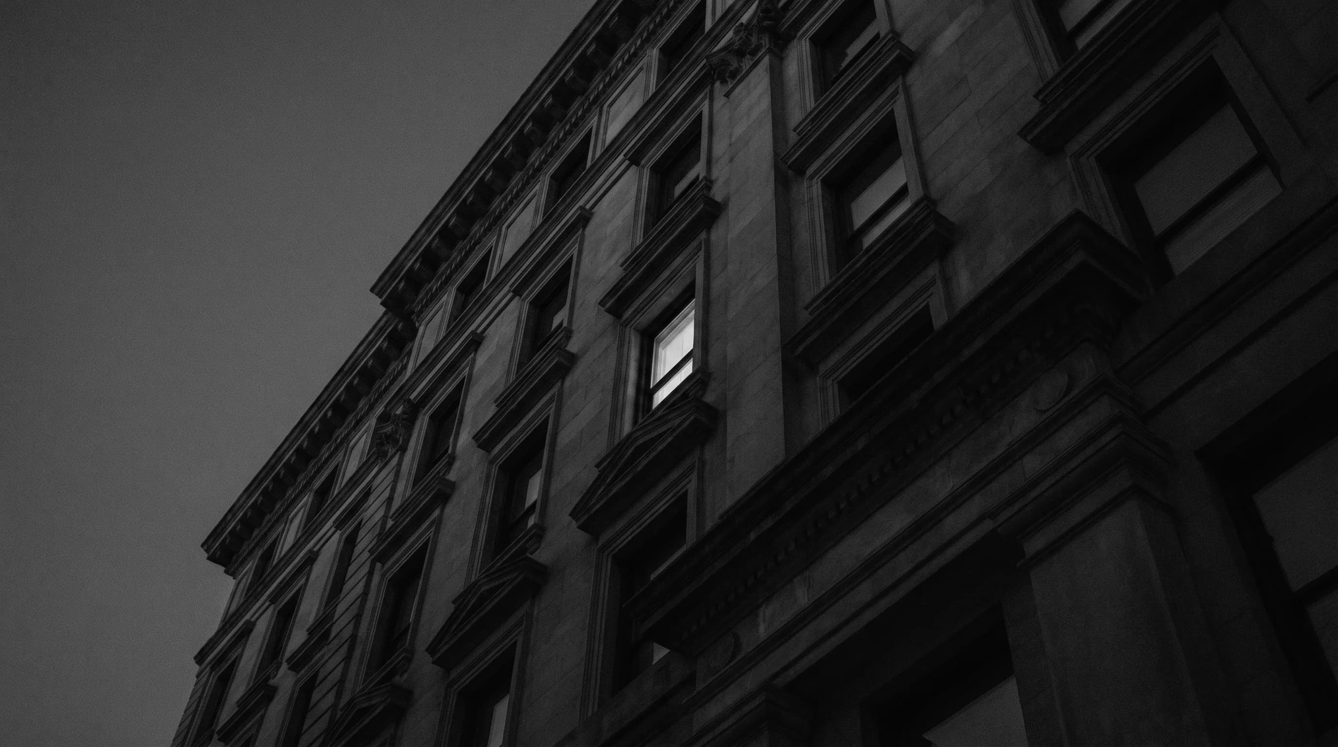 A restored residential facade at dusk, representing homes transformed into premier living conditions
